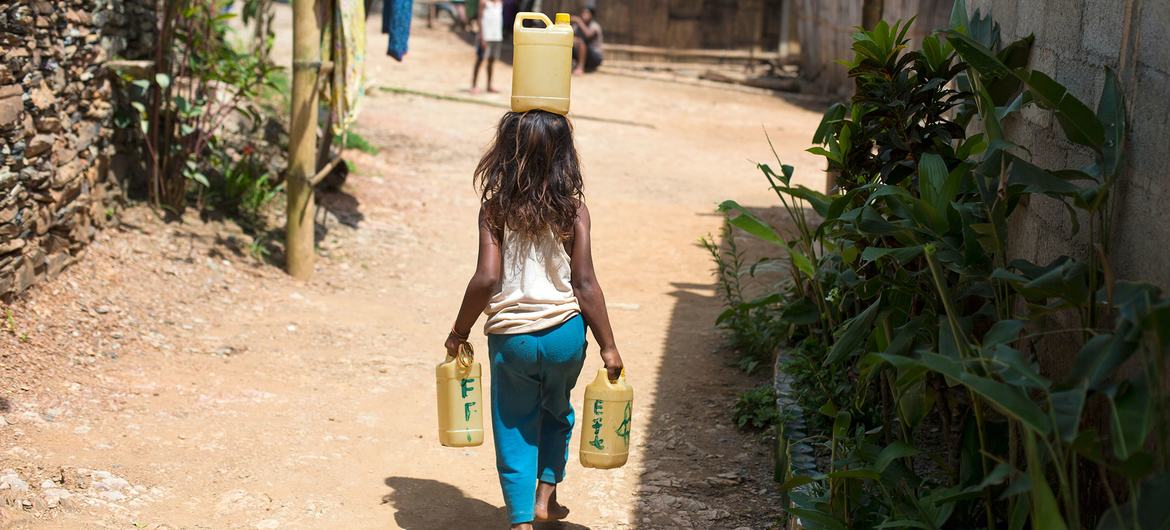 A six-year-old girl is carrying water from a fountain, which is far away from her house in Letefoho, Hatugau, Ermera municipality, Timor-Leste.