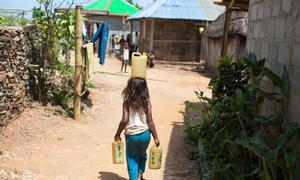 A six-year-old girl is carrying water from a fountain, which is far away from her house in Letefoho, Hatugau, Ermera municipality, Timor-Leste.