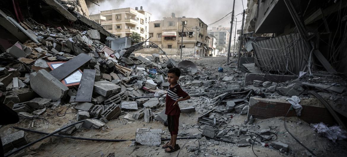 A boy looks across his bombed out neighbourhood in Gaza.