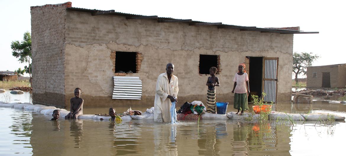A family outside their flood damaged home in N'Djamena, Chad. (file) A family outside their flood damaged home in N'Djamena, Chad. (file)