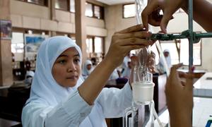 A student works in a chemistry lab in Indonesia's Yogyakarta Province.
