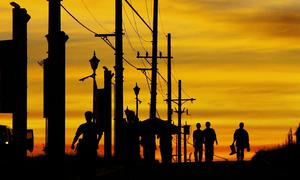 Construction workers walk along a road in Daan Hari, Philippines.