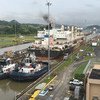A ship passes through a section of the Panama Canal, one of the busiest trading routes in the world.