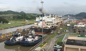 A ship passes through a section of the Panama Canal, one of the busiest trading routes in the world.