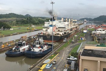 A ship passes through a section of the Panama Canal, one of the busiest trading routes in the world.