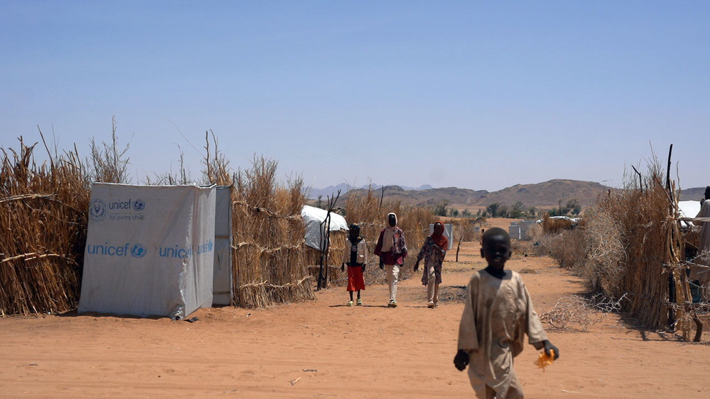 Displaced from El Fasher, an 11-year-old child makes their way through a settlement for displaced persons in Tawila, North Darfur.