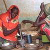 A woman prepares a meal for her family in El Fasher, North Darfur where people are trapped due to fighting