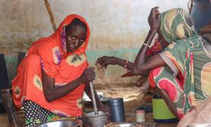 A woman prepares a meal for her family in El Fasher, North Darfur where people are trapped due to fighting