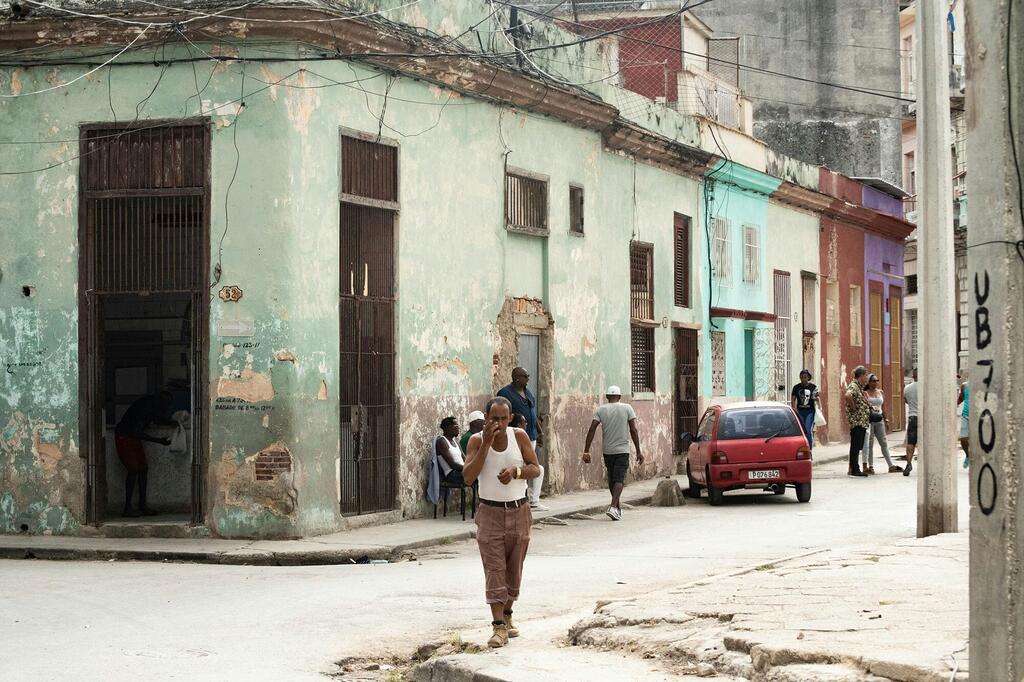 Mwanaume anavuka barabara katika mtaa wa Old Havana, jijini Havana, mji mkuu wa Cuba.