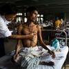 A doctor consults with a patient at hospital which teats TB in Mumbai, India.