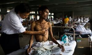 A doctor consults with a patient at hospital which teats TB in Mumbai, India.