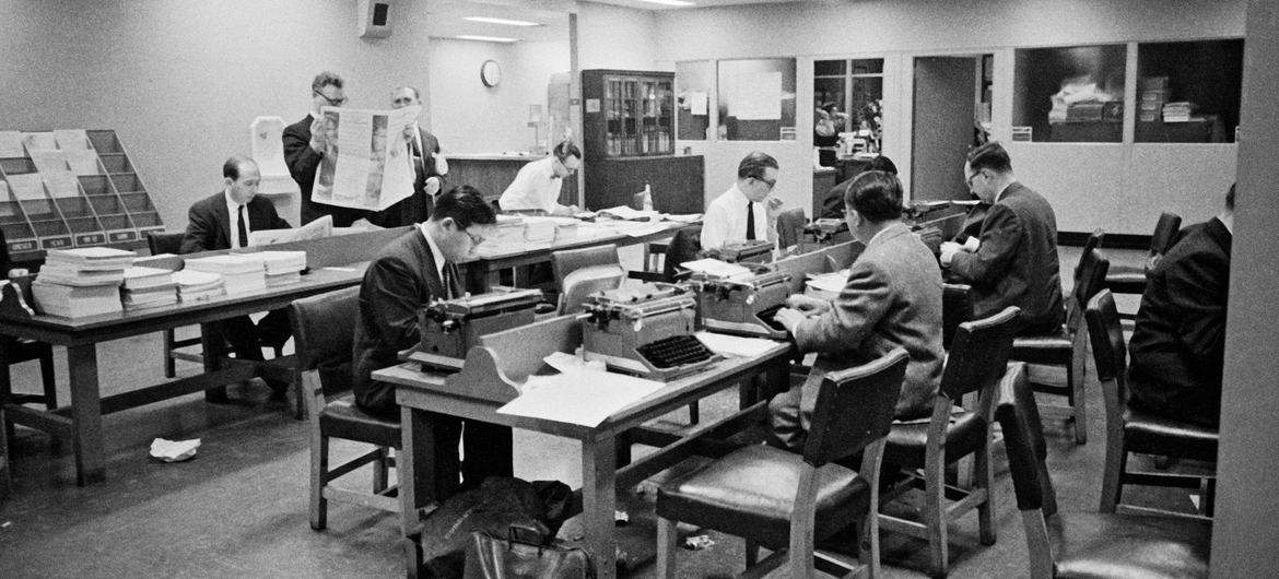 Journalists work late into the night at UN Headquarters during the first emergency special session in 1956. 