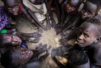 Children make a shape with their hands in the south Omo district of southern Ethiopia.