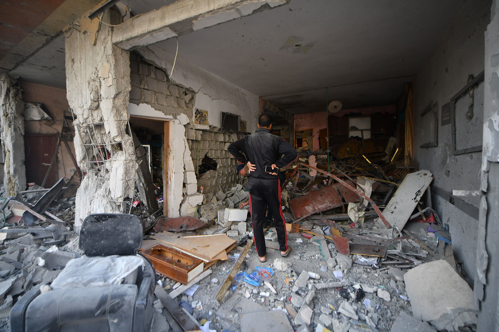 A man inspects his destroyed home in in Khan Younis city, in the south of the Gaza Strip.