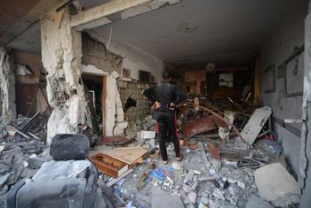 A man inspects his destroyed home in in Khan Younis city, in the south of the Gaza Strip.