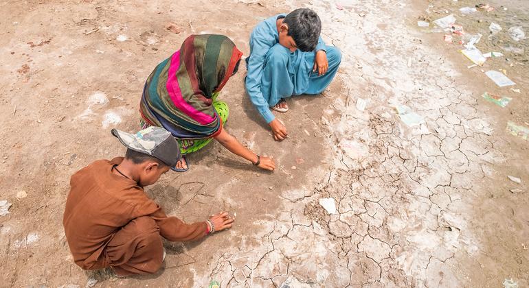 Children play on parched land in southern Pakistan.