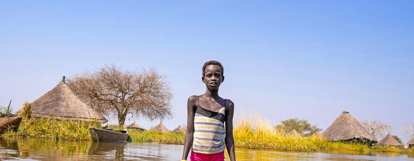 A child navigates flood waters in Jonglei State in South Sudan.