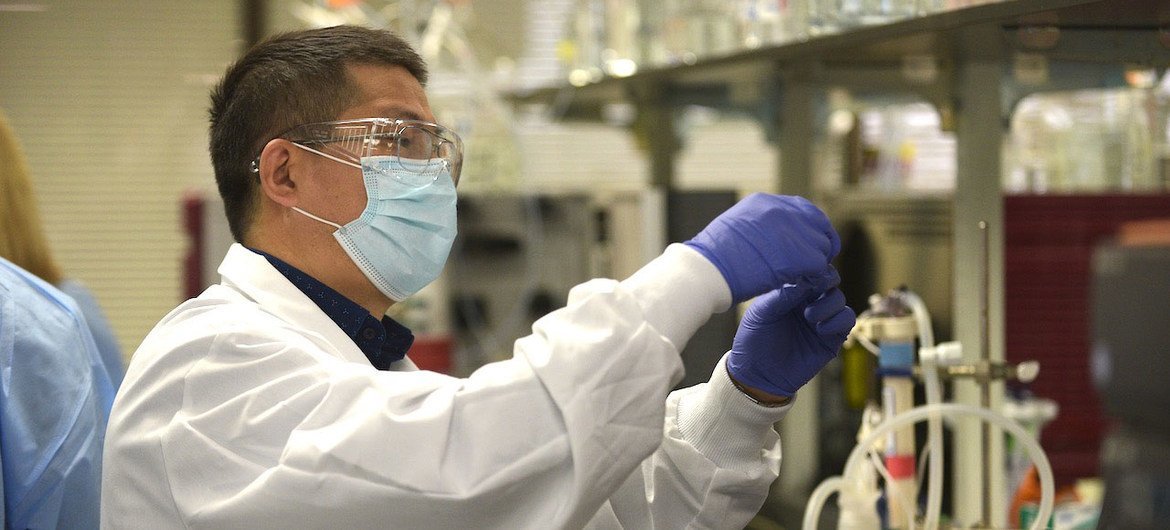 A scientist in the laboratory studies the Novavax COVID-19 vaccine.