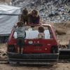 Children play on the wreck of a car in Gaza.