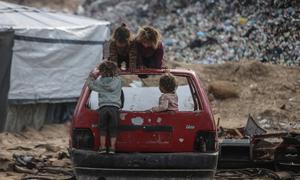 Children play on the wreck of a car in Gaza.