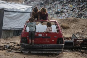 Children play on the wreck of a car in Gaza.