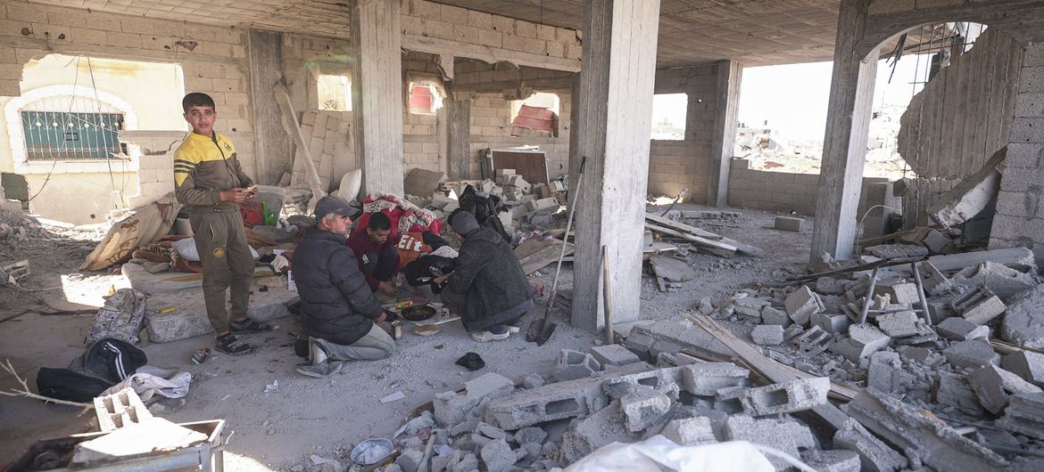 A family gathers in a damaged building in Rafah in the southern Gaza Strip.