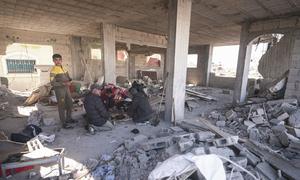 A family gathers in a damaged building in Rafah in the southern Gaza Strip.