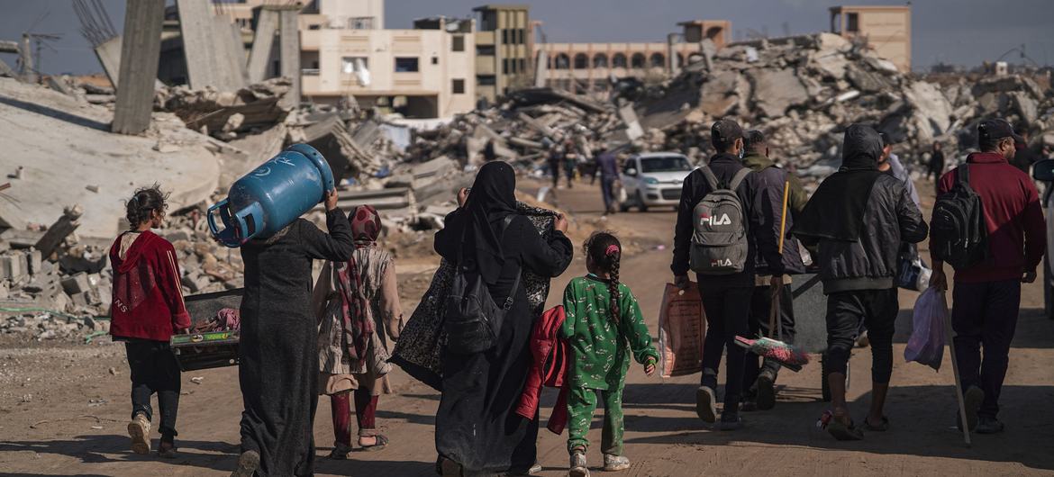 Displaced Palestinians walk through the destruction in Rafah in southern Gaza.