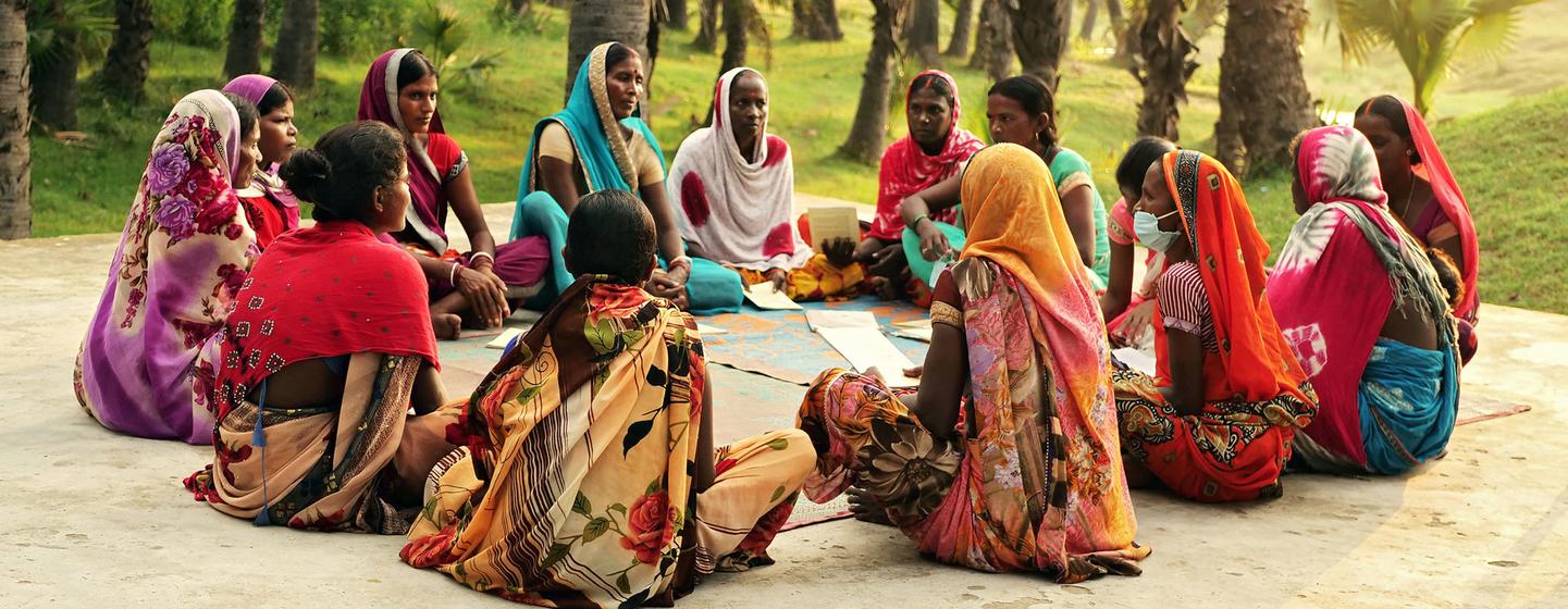 Women from a village in the state of Bihar, India, get together for a community meeting. 