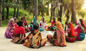 Women from a village in the state of Bihar, India, get together for a community meeting. 