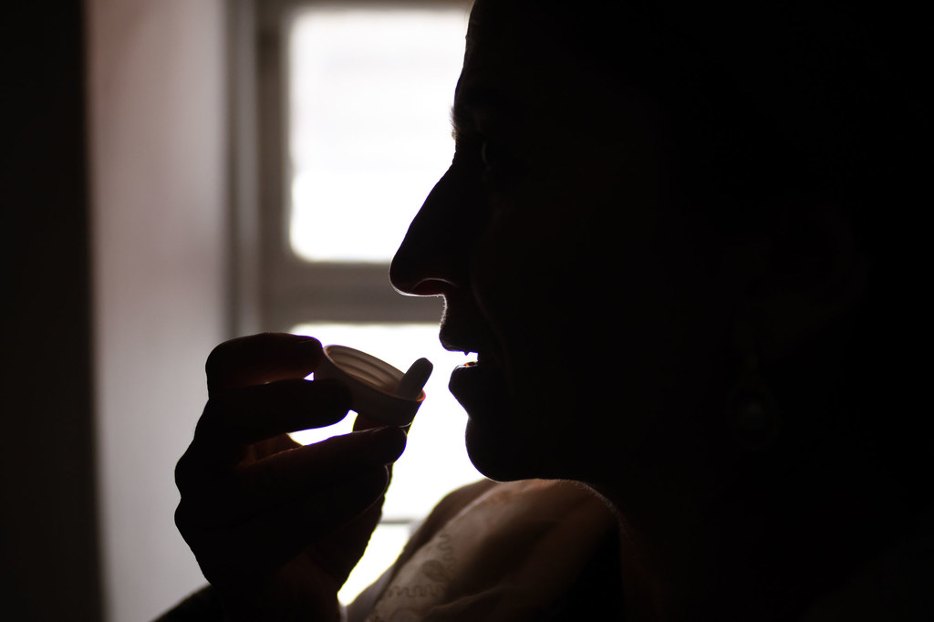 A woman living with HIV takes antiretroviral medication at home in Khatlon, Tajikistan.