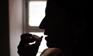 A woman living with HIV takes antiretroviral medication at home in Khatlon, Tajikistan.