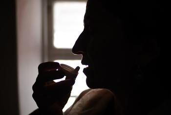 A woman living with HIV takes antiretroviral medication at home in Khatlon, Tajikistan.