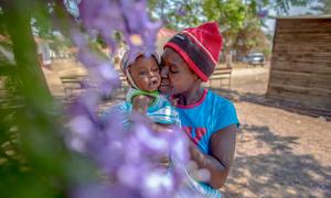 A 35-year-old HIV-positive mother holds her six-month-old baby.