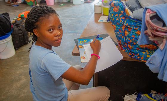 A teenage girl in Haiti studies in a shelter after her school was closed due to gang activity.