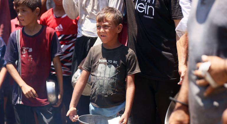 Families and children seeking food from a community kitchen in western Gaza City.