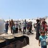 Families seek food at a community kitchen in western Gaza City.