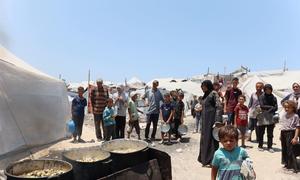Families seek food at a community kitchen in western Gaza City.
