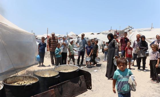 Families seek food at a community kitchen in western Gaza City.