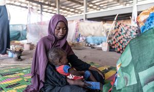 A mother looks after her child at a camp for displaced people in Gedaref, Sudan, after fleeing her home.