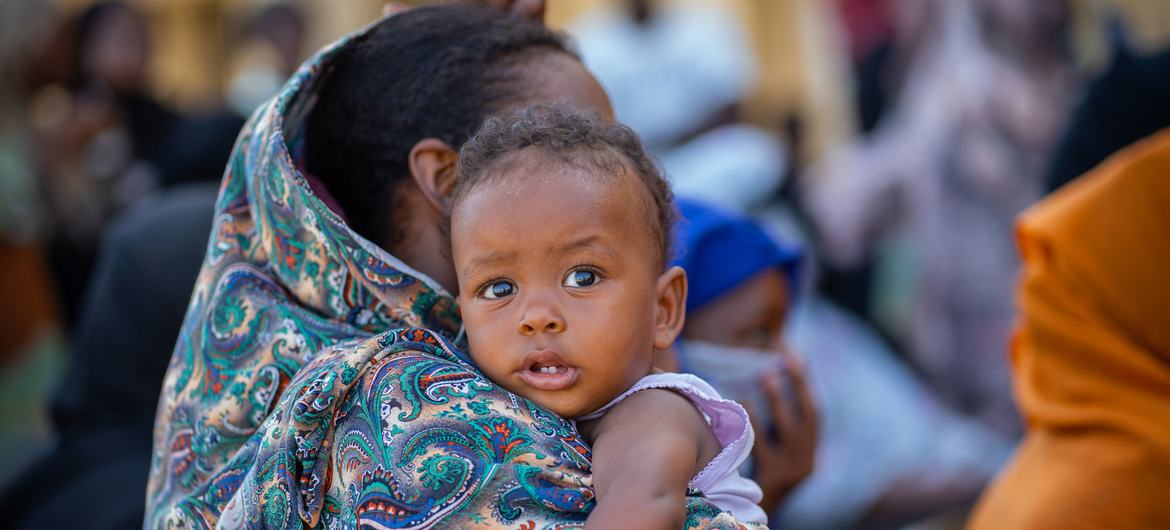 A mother carries her baby in Port Sudan, on the Sudanese coast.