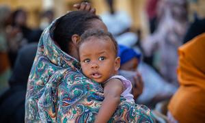 A mother carries her baby in Port Sudan, on the Sudanese coast.