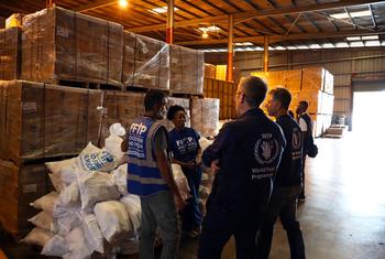 World Food Programme workers discuss the distribution of aid in a warehouse in Jamaica.