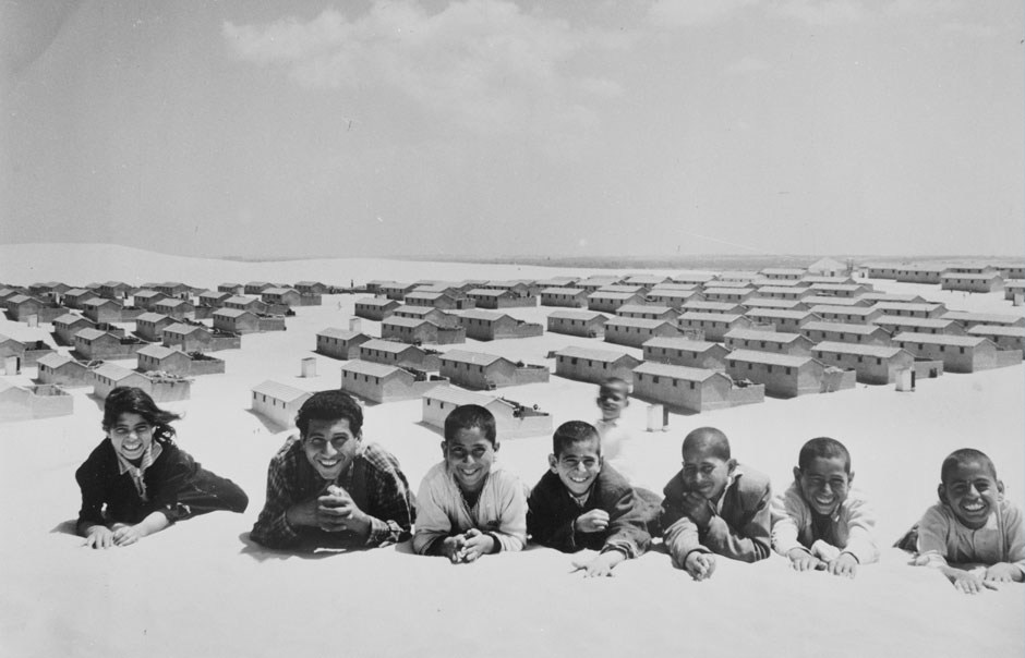 When this picture was taken at Khan Younis in 1955, the tented refugee camp in the Gaza Strip had just been replaced by cement block houses. These youngsters were happy to have more weatherproof shelter against the summer sun and winter rains.