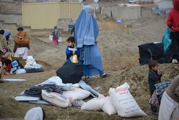A woman and her child walk through a camp for displaced people in Afghanistan (file).