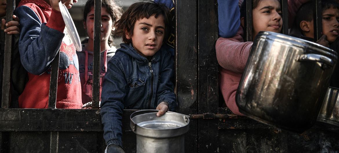 En Gaza, los niños esperan para recibir alimentos mientras continúan los bombardeos sobre el enclave. 