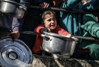 An 8-year-old child waits her turn to receive food in Rafah, in the southern Gaza Strip. (file)