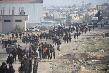 Displaced Palestinians walk along a street in Rafah, in the southern Gaza Strip.