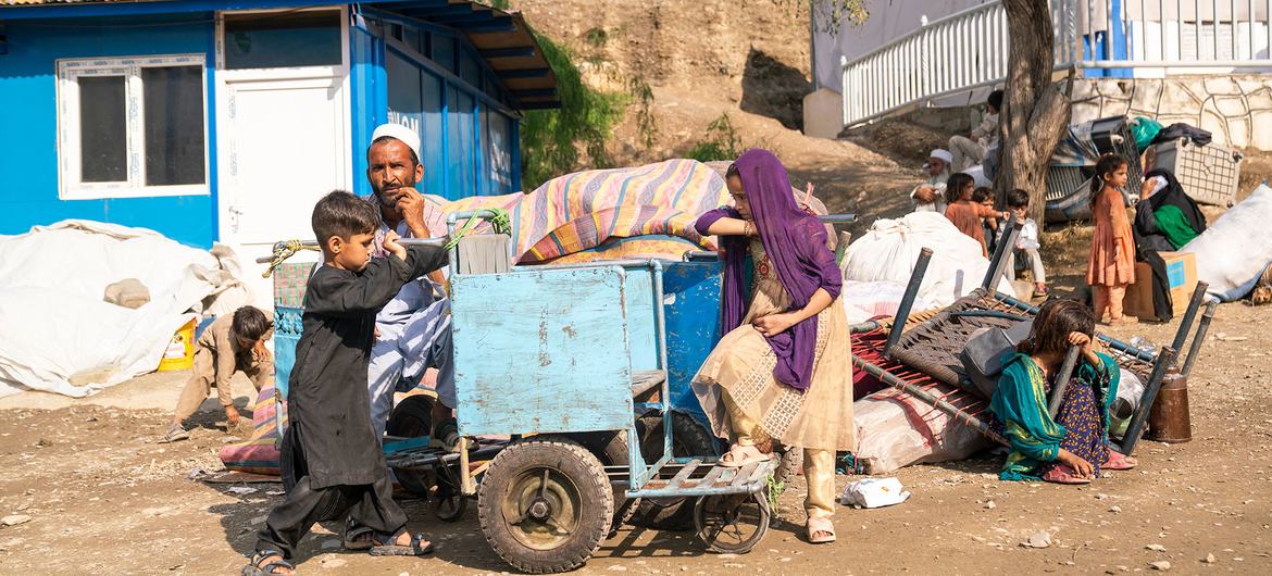 A family sit beside their belongings after crossing into Afghanistan from Pakistan. A family sit beside their belongings after crossing into Afghanistan from Pakistan.