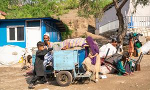 A family sit beside their belongings after crossing into Afghanistan from Pakistan.